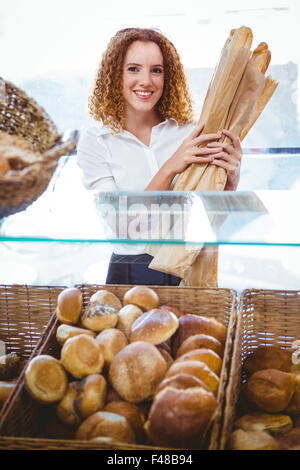 Hübsche Barista hält Laib Brot Stockfoto