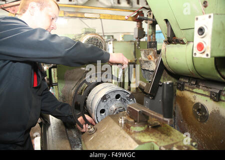 Junger Arbeiter betreibt Metall Detail Verarbeitung bei drehen Drehbank Stockfoto