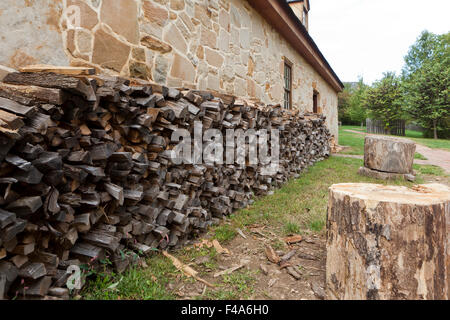 Erfahrene Brennholz gestapelt neben Wand - USA Stockfoto