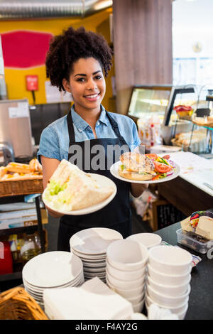 Hübsche Kellnerin das Mittagessen an Kamera Stockfoto
