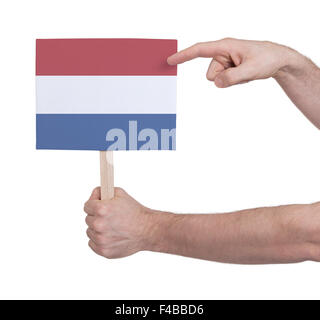 Hand, die kleine Karte, isoliert auf weiss - Flagge der Niederlande Stockfoto