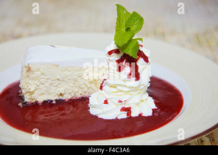 Käsekuchen mit Sahne in Obstkonfitüre Stockfoto