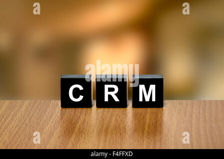 CRM oder Customer-Relationship-Management auf schwarzer Block mit unscharfen Hintergrund Stockfoto