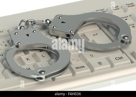 Kriminalität im Internet-Konzept, Handschellen auf Computer-Tastatur Stockfoto