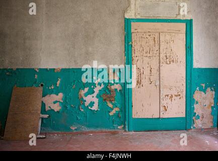 Alte im Alter Gebäude Fragment, zerstörten Haus. Fragment alte geschlossene Fabrik. Alte verlassene Türen mit selektiven Fokus. Zerstörten bauen Stockfoto