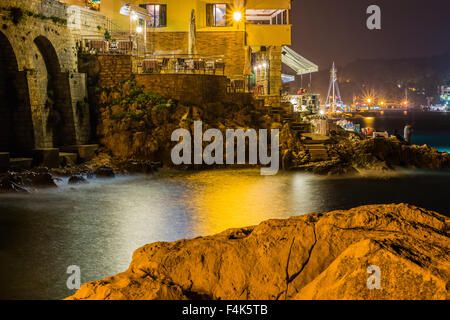 Meereswellen lash Linie Auswirkungen Felsen am Strand bei Nacht Stockfoto