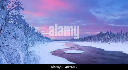 Eine schnelle in einem Fluss in eine winterliche Landschaft. Fotografiert an der Äijäkoski-Stromschnellen im Fluss Muonionjoki im finnischen Lappland im su Stockfoto