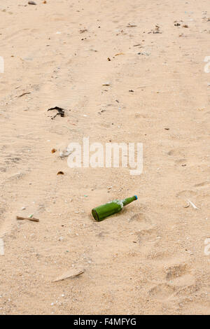 Kaputte Flaschen und anderen Müll am Strand verstreut liegen. Stockfoto