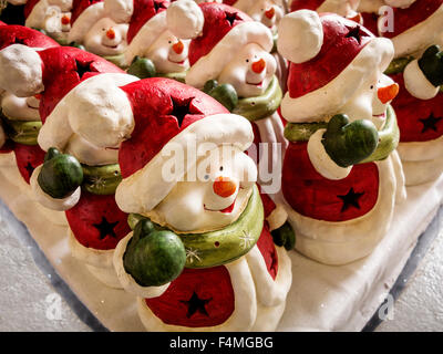 Schneemänner Ornamente in Weihnachtsmann Outfits zum Verkauf an ein Gartencenter aufgereiht Stockfoto