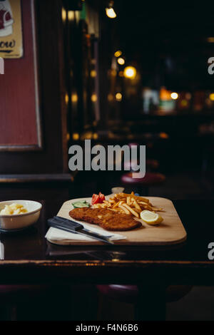 Wiener Schnitzel mit Pommes Frites am Tisch im restaurant Stockfoto