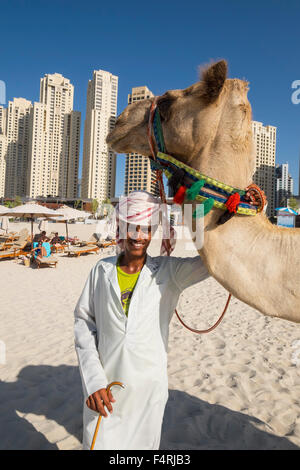 Touristischen Kamel und Besitzer am Strand im JBR Jumeirah Beach Residences im Marina District von Dubai Vereinigte Arabische Emirate Stockfoto