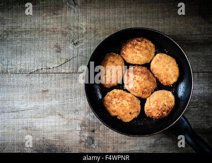 Koteletts vom Chiken Fleisch am Grill Pfanne auf den hölzernen Hintergrund. Saftig gebratenes Fleisch Schnitzel. Stockfoto