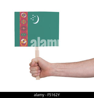 Hand, die kleine Karte, isoliert auf weiss - Flagge Turkmenistan Stockfoto