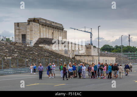 Touristen auf dem Zeppelinfeld, Haupttribüne, auf der Website der NSDAP Rallye Gelände in Nürnberg. Stockfoto