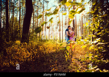 Romantische junge Paar küssen auf Hintergrund Sommer Wald Stockfoto