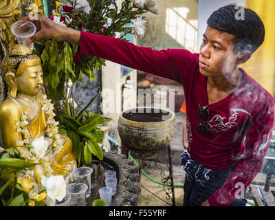 Thanlynn, Division in Yangon, Myanmar. 28. Oktober 2015. Ein Mann taucht einen Buddha mit Weihwasser während Gedenktage des Thadingyut Kyaik Khauk Pagode. Das Thadingyut Festival, die Beleuchtung Festival von Myanmar, ist am Vollmondtag des birmanischen lunaren Monats des Thadingyut statt. Als ein Brauch ist es am Ende der buddhistischen Fastenzeit (Vassa) statt. Das Thadingyut Festival ist die Feier, die Buddha Abstieg vom Himmel begrüßen zu dürfen. © Jack Kurtz/ZUMA Draht/Alamy Live-Nachrichten Stockfoto