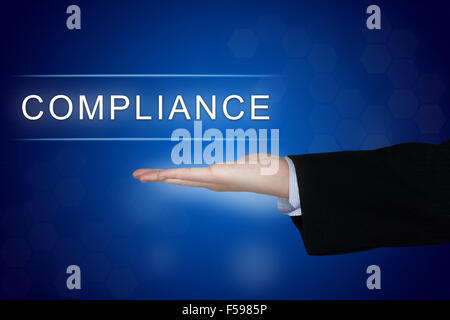 Compliance-Taste mit Business Hand auf blauem Hintergrund Stockfoto