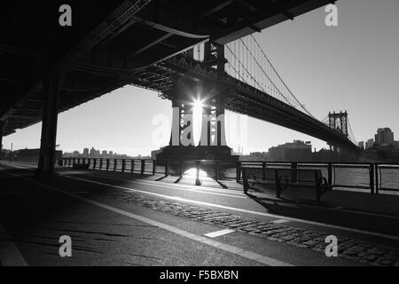 Die Sonne geht über Brooklyn und wirft Schatten auf den East River Esplanade, New York Stockfoto