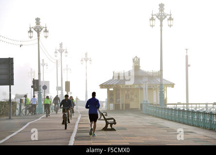 Brighton Sussex UK haben Montag, 2. November 2015 - Radfahrer und Läufer keine Probleme mit den nebligen Reisebedingungen an Brighton Strandpromenade Vormittag Stockfoto