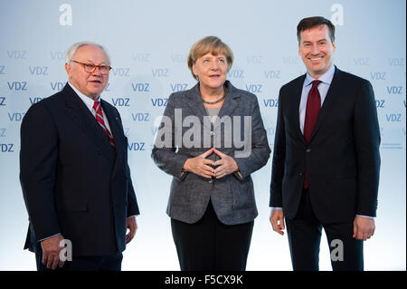 Berlin, Deutschland. 2. November 2015. Hubert Burda (L), Herausgeber und Präsident der Vereinigung von deutscher Zeitschrift Verleger (VDZ) und Stephan Scherzer (R), Geschäftsführer der VDZ, grüßen die deutsche Bundeskanzlerin Angela Merkel am "Publishers Gipfel 2015" - der deutsche Zeitschriftenverlage Konferenz - in Berlin, Deutschland, 2. November 2015. Der Verband der deutscher Zeitschrift Verleger (VDZ) organisiert der jährliche Branchentreff der deutschen Zeitschriften. Foto: BERND VON JUTRCZENKA/Dpa/Alamy Live-Nachrichten Stockfoto