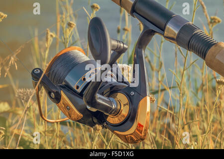 An den Ufern des schönen Flusses oberhalb der Wasser-Feeder installiert - Englisch Angelgerät für den Fang von Fischen mit Stockfoto