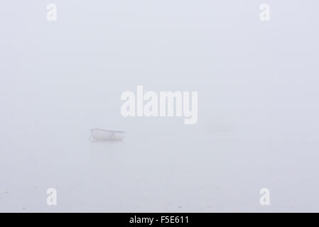 Ein Boot, fast versteckt im Nebel, aufgenommen an einem Herbsttag an Leigh am Meer Stockfoto