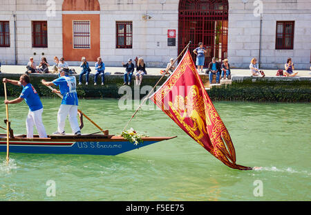Ein Team, die Teilnahme an der Vogalonga, mit dem Boot unter der venezianischen Flagge eines geflügelten Löwen Venedig Veneto Italien Europa Stockfoto