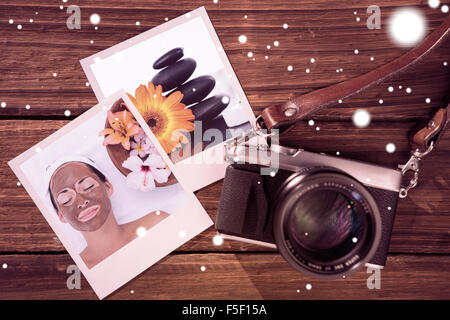 Zusammengesetztes Bild des lächelnden Brünette immer eine Schlammbehandlung Gesicht neben Schale mit Blumen Stockfoto