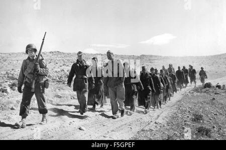 Nordafrika-Kampagne im 2. Weltkrieg. Ein amerikanischer Soldat mit einer Gruppe von italienischen Gefangenen gegen Ende der Kampagne im Mai 1943 Stockfoto