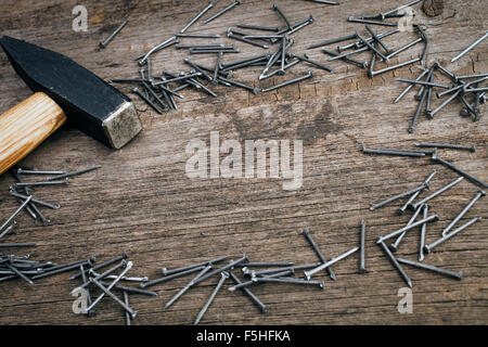 Metal Hammer und Nägel auf Holzbrett Stockfoto