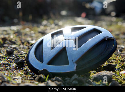 Achim, Deutschland. 4. November 2015. Eine beschädigte VW-Emblem liegt auf dem Boden auf einem Parkplatz in Achim, Deutschland, 4. November 2015. Der VW-Emissionen-Skandal scheint zu eskalieren. VW-Aktien sind wieder gesunken. Foto: INGO WAGNER/Dpa/Alamy Live News Stockfoto