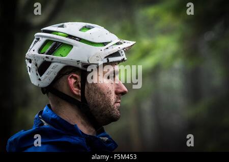 Profilbildnis von männlichen Mountainbiker mit Schlamm bespritzt Stockfoto