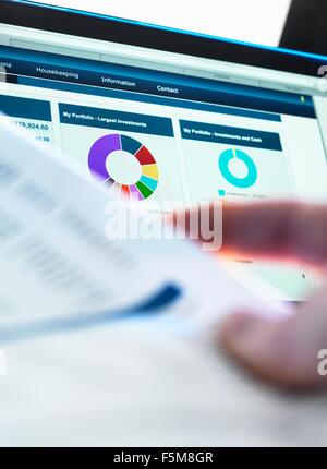 Anleger, die Performance der finanziellen Portfolio online überprüfen, während Investition Anweisung überprüfen Stockfoto