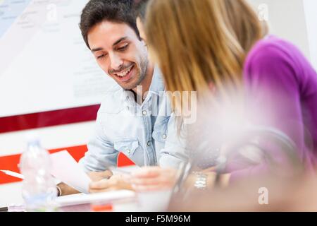 Mann und Frau sitzen zusammen, lachen Stockfoto