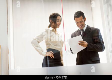Geschäftsmann und Geschäftsfrau auf der Suche auf Dokumente, Gespräch Stockfoto