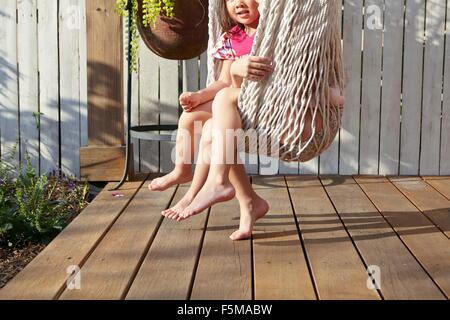 Mädchen in der Hängematte auf der Veranda sitzen Stockfoto