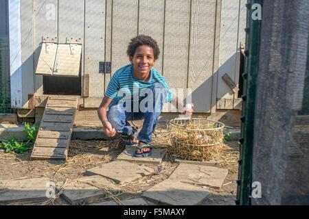 Porträt eines jungen im Hühnerstall sammeln von Eiern Stockfoto