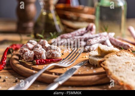 Satz von Salami Wurst mit frischem Brot auf Holzbrett serviert Stockfoto