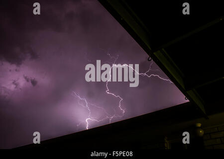 Blitz schlägt in einem Haus im Vorort bei Gewitter. Stockfoto