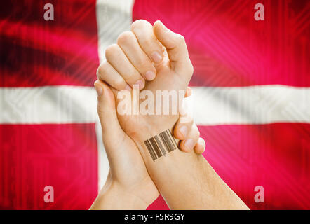 Barcode-ID-Nummer am Handgelenk einer menschlichen und nationale Flagge auf Hintergrund - Dänemark Stockfoto