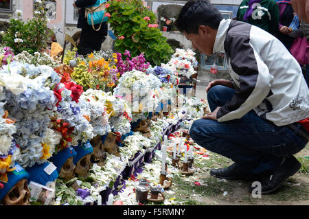 La Paz, Bolivien. 8. November 2015. Ein Mann wacht Schädel während der Feier des Tages der "Natitas" in die allgemeine Friedhof von La Paz, Bolivien, am 8. November 2015. Der Tag des "Natitas" ist am achten Tag November in Bolivien statt. Die "Natitas" sind menschliche Schädel, die gepflegt und geschmückt von den Gläubigen, die verwenden sie als Amulette, die glauben, dass sie als Schutz dienen. Das Festival ist eine Mischung aus Anden Ahnenverehrung und katholischen Glauben, die mit Ritualen mit Blumen, Nahrung, Coca war, Cigarretts, Alkohol, Musik-Bands gehalten wird. Bildnachweis: Xinhua/Alamy Live-Nachrichten Stockfoto