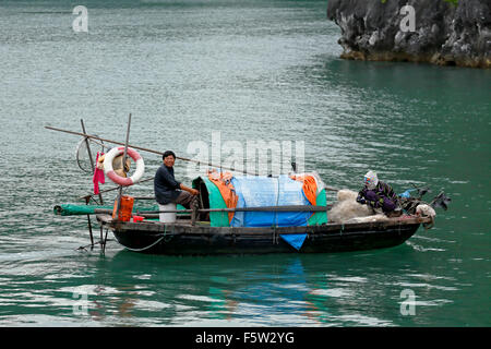 Fischer und Fischerboot, Ha Long Bucht, Bai Tu Long Sektor, in der Nähe von Ha Long, Vietnam Stockfoto