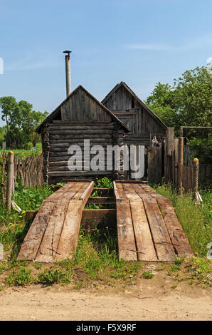 Hölzerne Track für die Reparatur von Autos, ein Bad, Schuppen, Garten im Dorf. Stockfoto