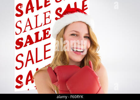 Zusammengesetztes Bild des Lächelns blonde tragen rote Boxhandschuhe Stockfoto