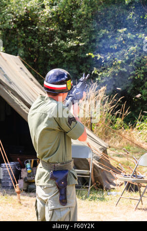 Vietnam Krieg Re-enactment. Das amerikanische Militär Polizist, MP, ständigen Feuern M16 in voller platzen. Patronenhülsen Auswerfen aus dem Gewehr. Stockfoto