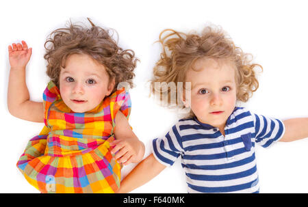 Kleine Jungen und Mädchen Blick in die Kamera auf weißem Hintergrund Stockfoto