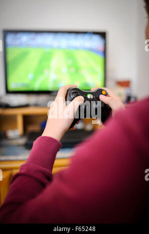 ILLUSTRATION - spielt ein Junge "Fifa 15" auf seiner Xbox 360 S. Das Foto wurde am 6. Januar 2015 in Dresden (Sachsen). Foto: Thomas Eisenhuth Stockfoto