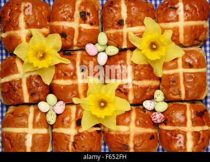 Hot Cross Buns dekoriert mit Narzissen und Schokoladeneier zu Ostern, England UK Stockfoto