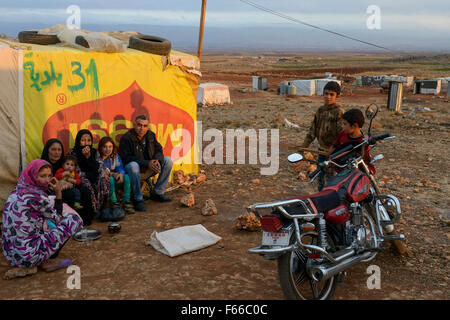 Libanon Beqaa Tal Deir el Ahmad, Lager für syrische Flüchtlinge, Familie im Zelt aus MAGGI-Werbeplakat / LIBANON Bekaa Tal, Deir el Ahmad, Syrische Camp Fuer Fluechtlinge am Dorfrand Stockfoto