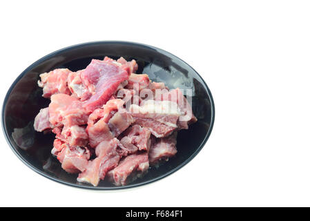 Haufen von rohem Schweinefleisch Knochen auf Platte Stockfoto